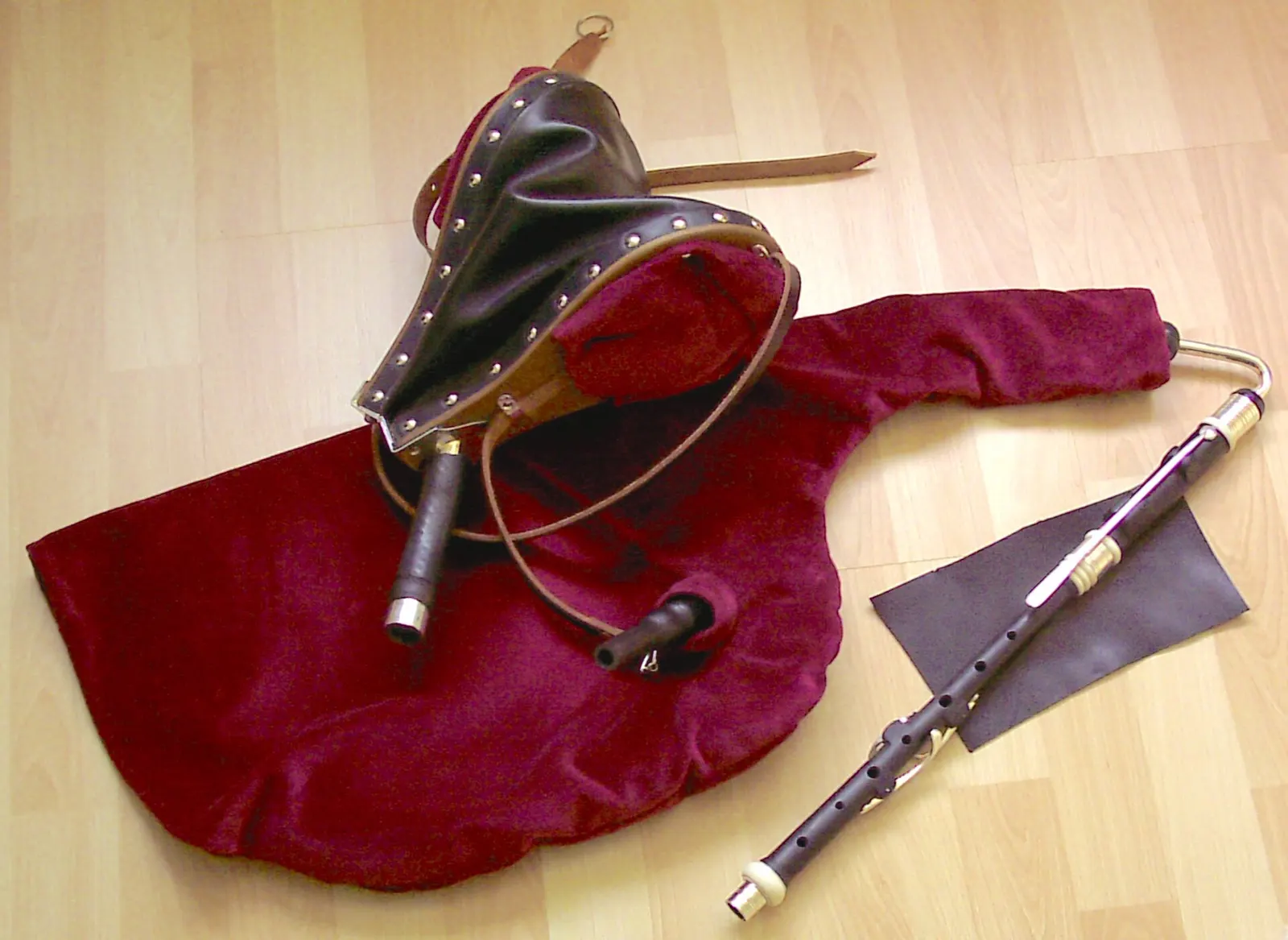 A practice set of Irish uilleann pipes with bag, bellows and chanter laid out on a table